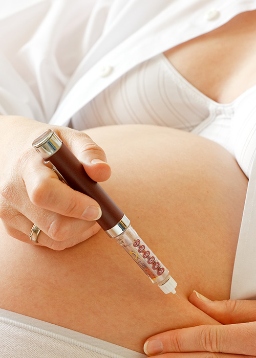 Femme enceinte atteinte de diabète gestationnel mesurant sa glycémie par piqûre au doigt